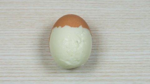 Boiled egg on a wooden background. Stop motion