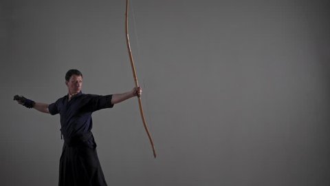 Man practicing Kyudo bow shooting.