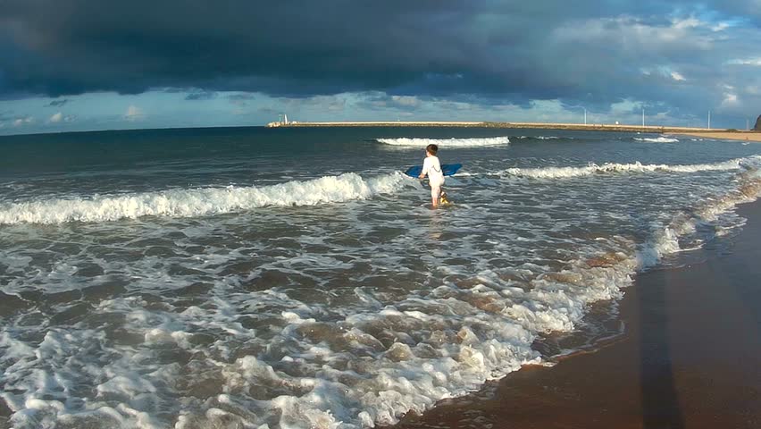 Surfing on awesome beach before thunderstorm. Filmed in Durban, East Coast of South Africa