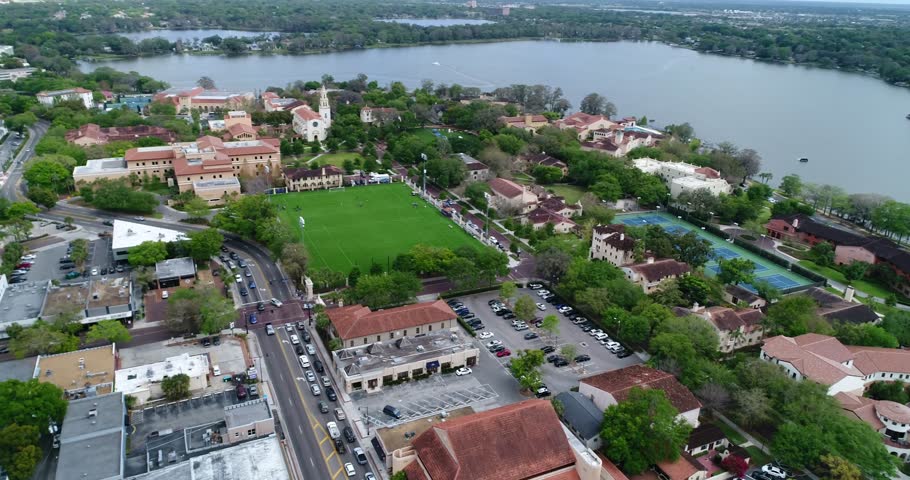 High aerial view over Rollins College campus, historic buildings, green lawns, and Lake Virginia in Winter Park, 2017.