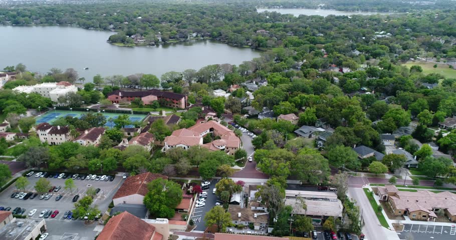 High aerial panorama of Rollins College, Lake Virginia, green residential blocks, and Winter Park, Florida, 2017.
