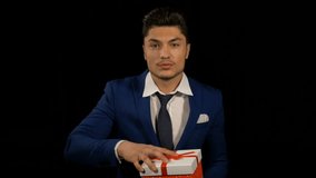 Businessman showing and opening a surprise gift box package