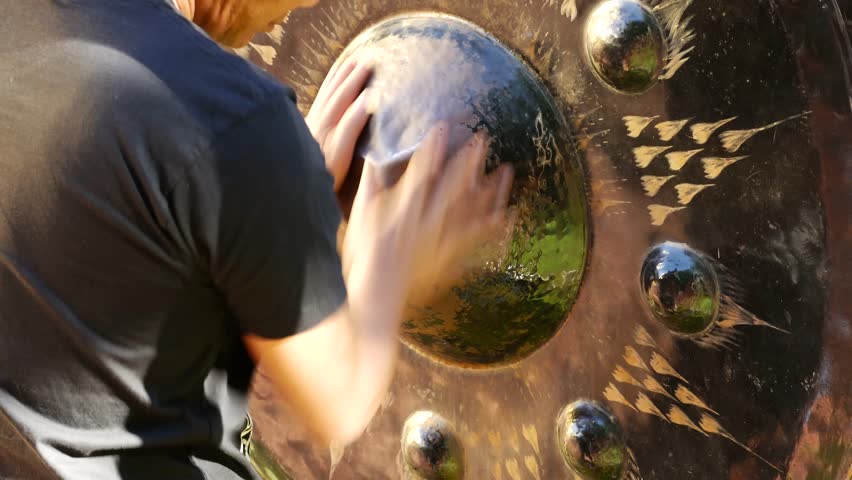 Man hand touch bells in Buddhist temple, Chiang Mai, Thailand. Praying hands on big Gong or bell in Buddhism temple in Wat Phra Sing Waramahavihan Chiang Mai.