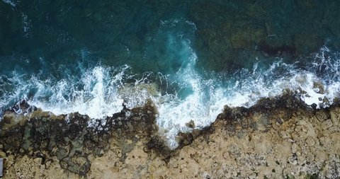 Waves crashing on stone coast. Drone 