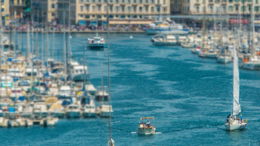 Busy traffic in Old Port of Marseille, boats sailing into open sea, timelapse