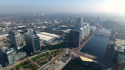 Panning aerial view of Media City and Salford Quays in Manchester, UK.