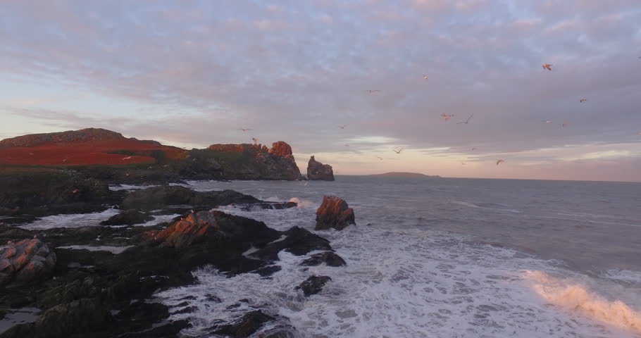 Drone shot along rough coastline Ireland's eye, Ireland during sunset. Royalty-Free Stock Footage #26081660