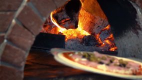 High quality video of man putting pizza to brick oven in real 1080p slow motion 250fps