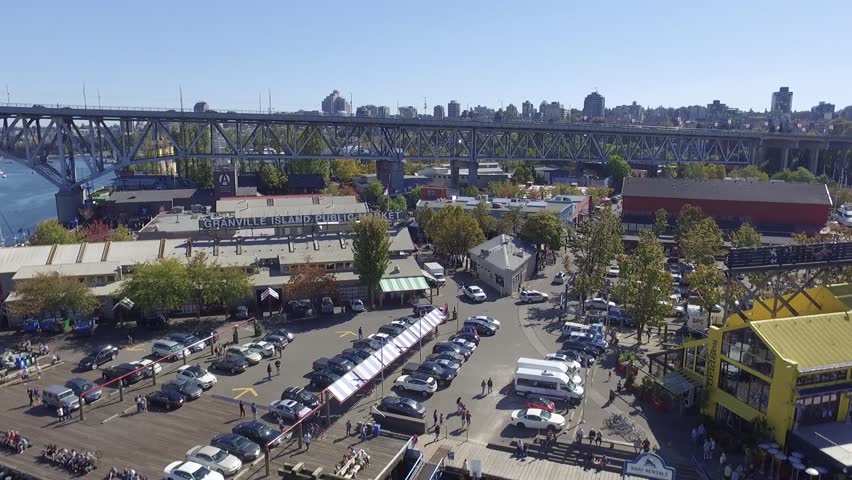 Aerial of Granville Island Public Market and Granville Bridge with Seagulls From Parking Lot