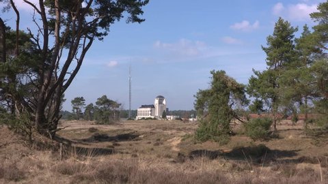 RADIO KOOTWIJK, NETHERLANDS - MARCH 2017: Building A and transmission mast of the former (1920s)  Dutch radio communication facility ,located on the Kootwijkerzand nature reserve.