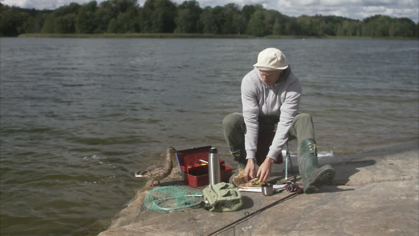 A man having a coffee break during a fishing tour