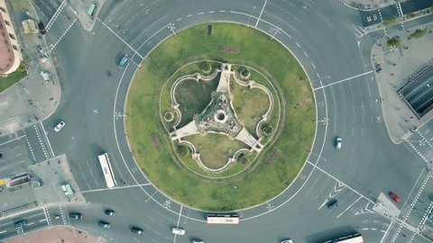 Aerial rising shot of Plaza de Espana in Barcelona, Spain. Roundabout city traffic, top view. 4K video