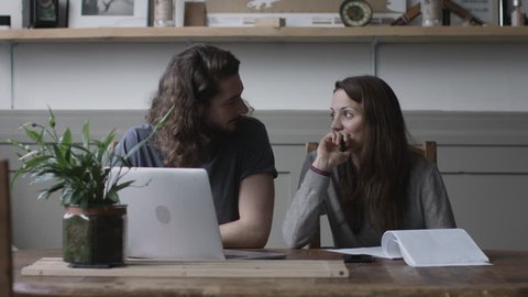 Young adult couple using a working on finance application together