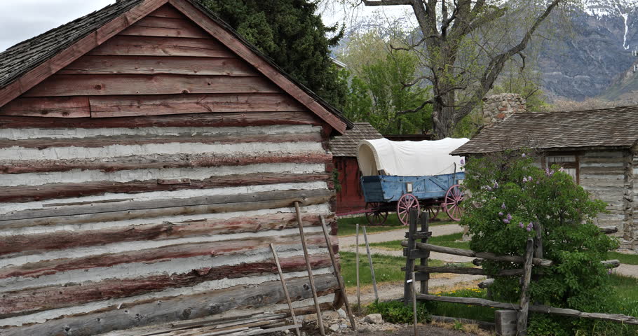Establishing shot-Static-Pioneer village cabins covered wagon mountain