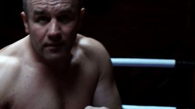boxer posing and training in dark ring