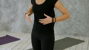 Beautiful young women in sportswear practicing breathing yoga exercise, yoga trainer explain the asana