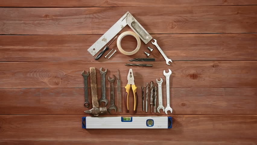 Top view time-lapse of a hand laying on wodden table conceptual house using constuction tools and stuff