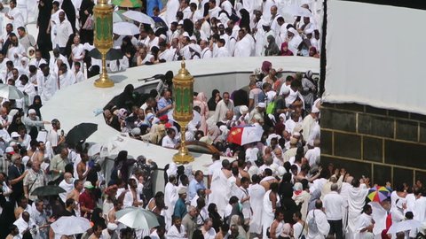 Mecca, Saudi Arabia - September 10, 2016: Muslim pilgrims put on their white ihrams praying in hijr ismail next to the holy Kaaba during Hajj in Saudi Arabia