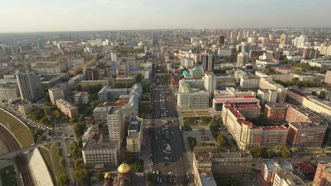 Aerial flight above Novosibirsk center. Main street. Theater roof from high altitude. Drone helicopter forward fast movement