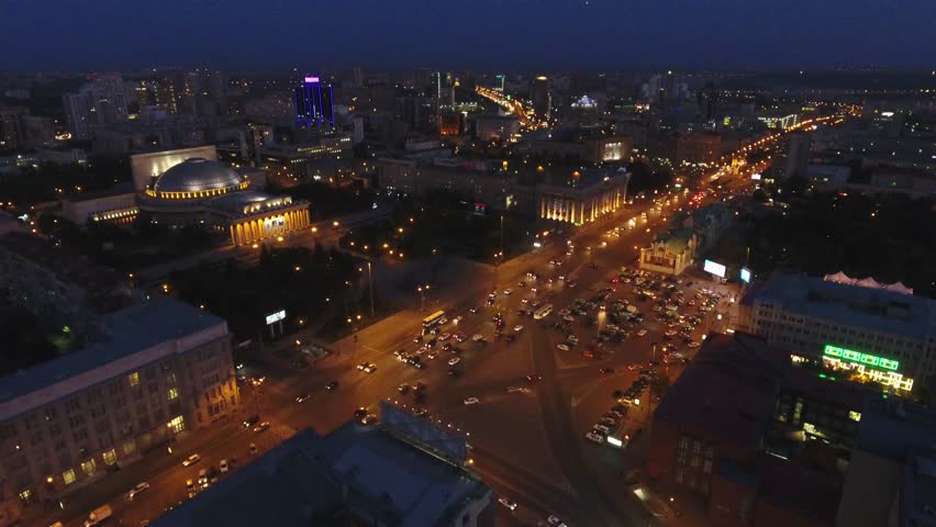 Novosibirsk main street square State Academic Opera and Ballet Theater important. Night city lighting from great height. Road traffic Buildings. Summer. Aerial  footage.