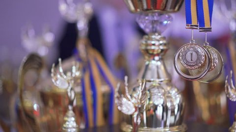 Close up of golden trophies on competition in 4K