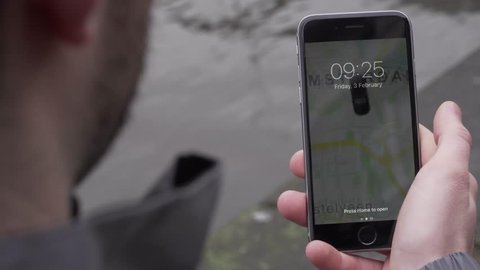 Delivery guy checks smartphone app for orders