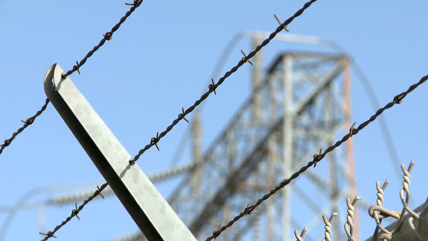 Focus/Defocus of a Barbwire Fence with power pylons in the background