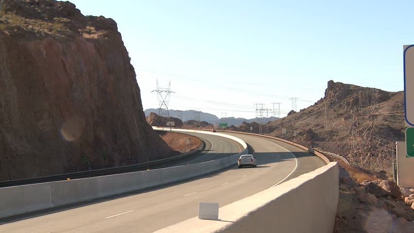 HOOVER DAM, NEVADA FEB 29, 2012: Traffic with pan to Welcome to Nevada Sign near