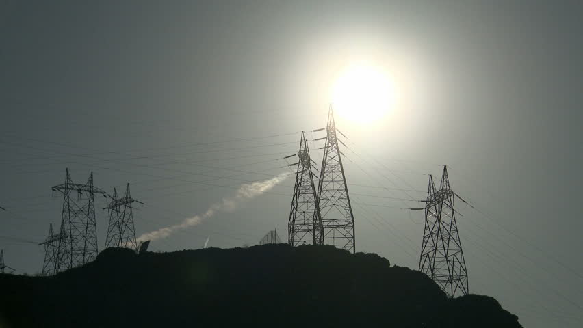 Time lapse Power Lines and a group of Power Towers in the sun