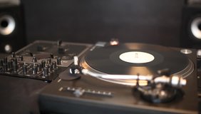 DJ spinning, mixing and scratching in music studio