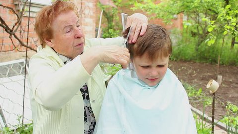 Grandmother cuts child's hair