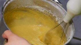 Mixing cake mixture to bake a pie.