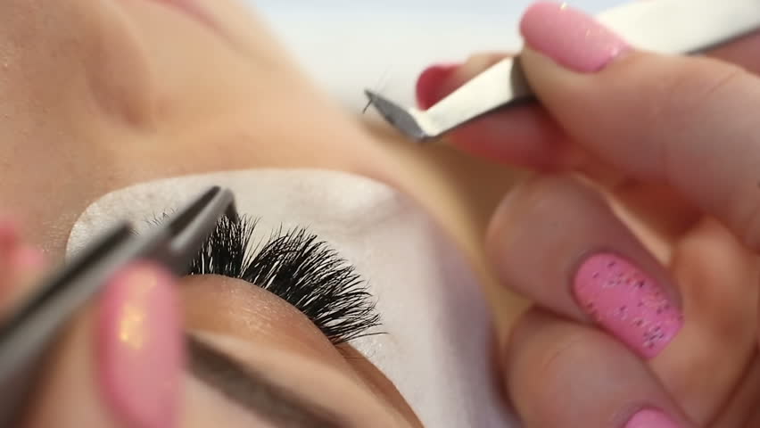 Eyelash Extension Procedure. Woman Eye with Long Eyelashes. Lashes, close up, macro, selective focus. Royalty-Free Stock Footage #26143109