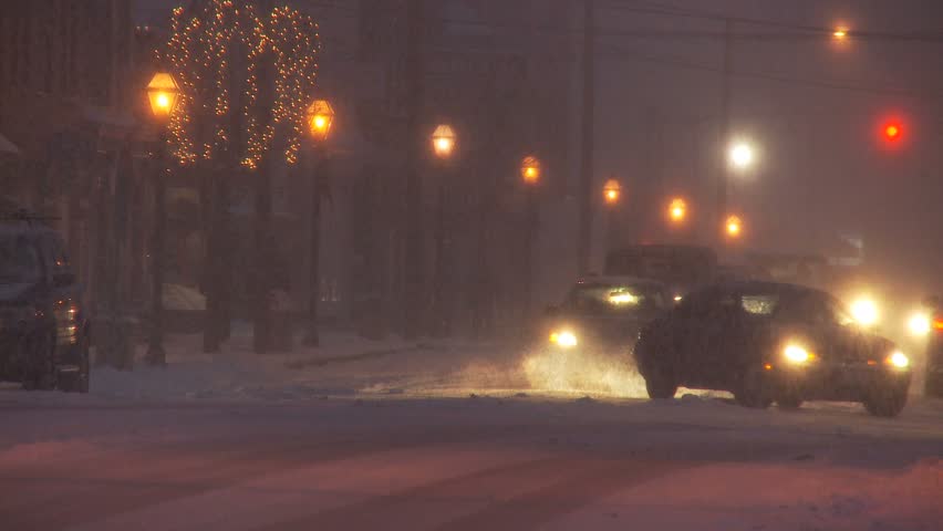 NEW ENGLAND - CIRCA NOVEMBER 2009: Small downtown scene with cars and lights during heavy snow storm at night | Shutterstock HD Video #2614370