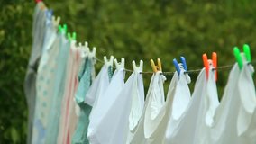 Clean Washed Clothes hanged on wire with clothes peg and blurred Spring Nature background