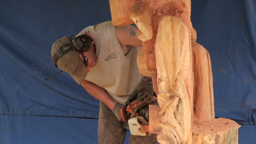 KNUTSFORD, CHESHIRE/ENGLAND - JUNE 19: Unidentified man carves wood at the Cheshire County Show on June 19, 2012 in Knutsford. The Cheshire County Show is an annual two-day agricultural show. | Shutterstock HD Video #2615192