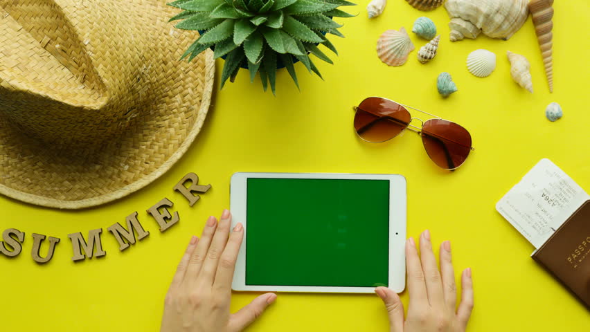 Young woman hand using tablet. Top view. Chroma key, Green screen.