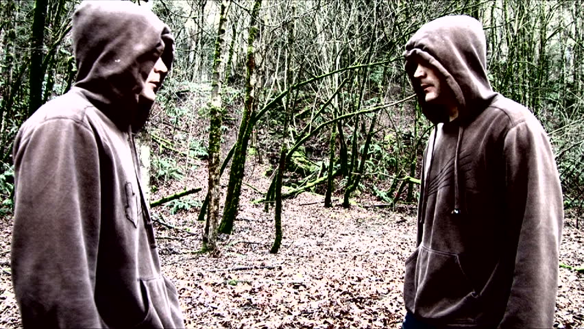 Twins running fast through eerie forest appear side by side breathing heavily,