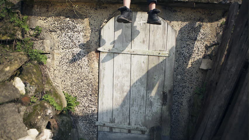 Boy is sitting on the roof of the shelter and enjoing the warm summer day