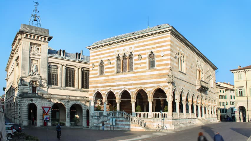 Timelapse of Udine, people walking in the street near Loggia del Lionello in the main city of Friuli-Venezia Giulia
