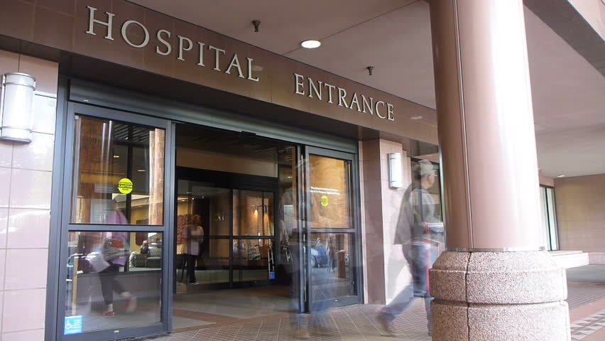 Time lapse effect at hospital entrance with patients entering and exiting