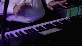 Closeup shot of keyboardist male hands playing synthesizer at party. 4k UHD video