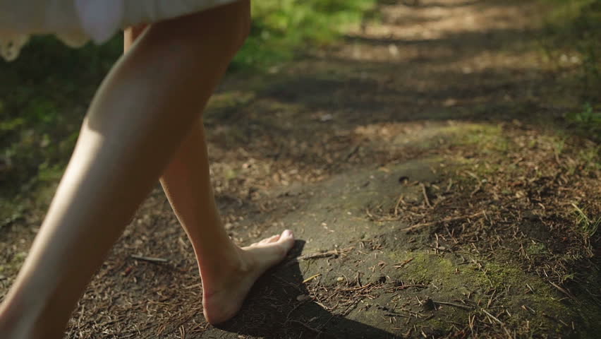 Walking woman in the forest with a white dress and bare foot Royalty-Free Stock Footage #26166377