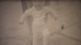 Family chronicle: Mother teach their child to walk. 8mm retro camera.