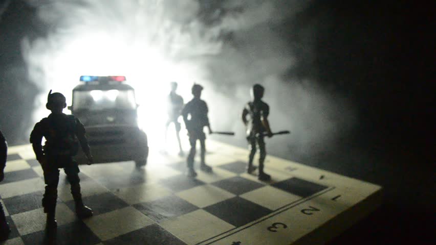 Anti-riot police give signal to be ready. Government power concept. Police on chessboard. Smoke on a dark background with lights. Blue red flashing sirens. Dictatorship power | Shutterstock HD Video #26174666