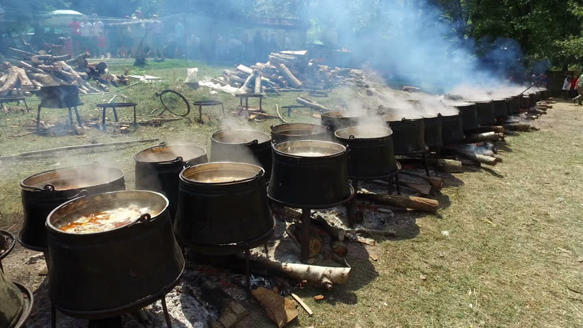 Cooking outdoors in cast-iron cauldron. Cooking meat food on a fire in nature.