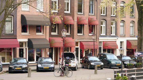 Amsterdam, April 2017. Prostitute windows with red canopies on canal in Amsterdam.
