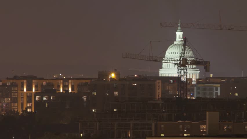 US Capitol Shrouded by Industrial Construction at Night

