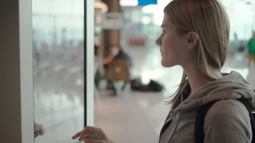 Beautiful attractive woman in airport terminal. Choosing food via self-service machine at fast food restaurant or diner | Shutterstock HD Video #26180219