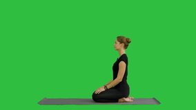 Woman doing Upward Dog Yoga Position, part of Sun Salutation on a Green Screen, Chroma Key